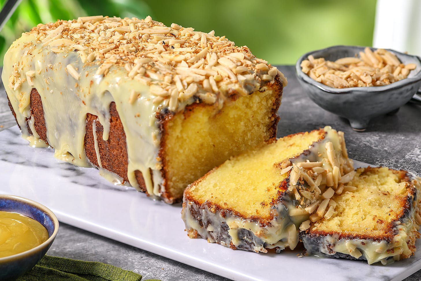 A lemon drizzle cake on a plate looks delicious.